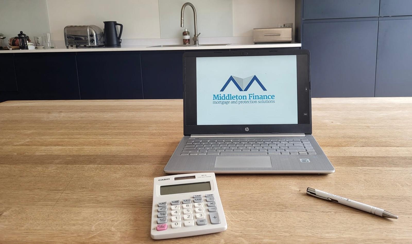 My trusty laptop, calculator, and pen — everything I need for mortgage consultations.